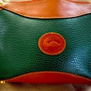 Beautiful forest green Dooney and Brooke purse with shoulder strap.
